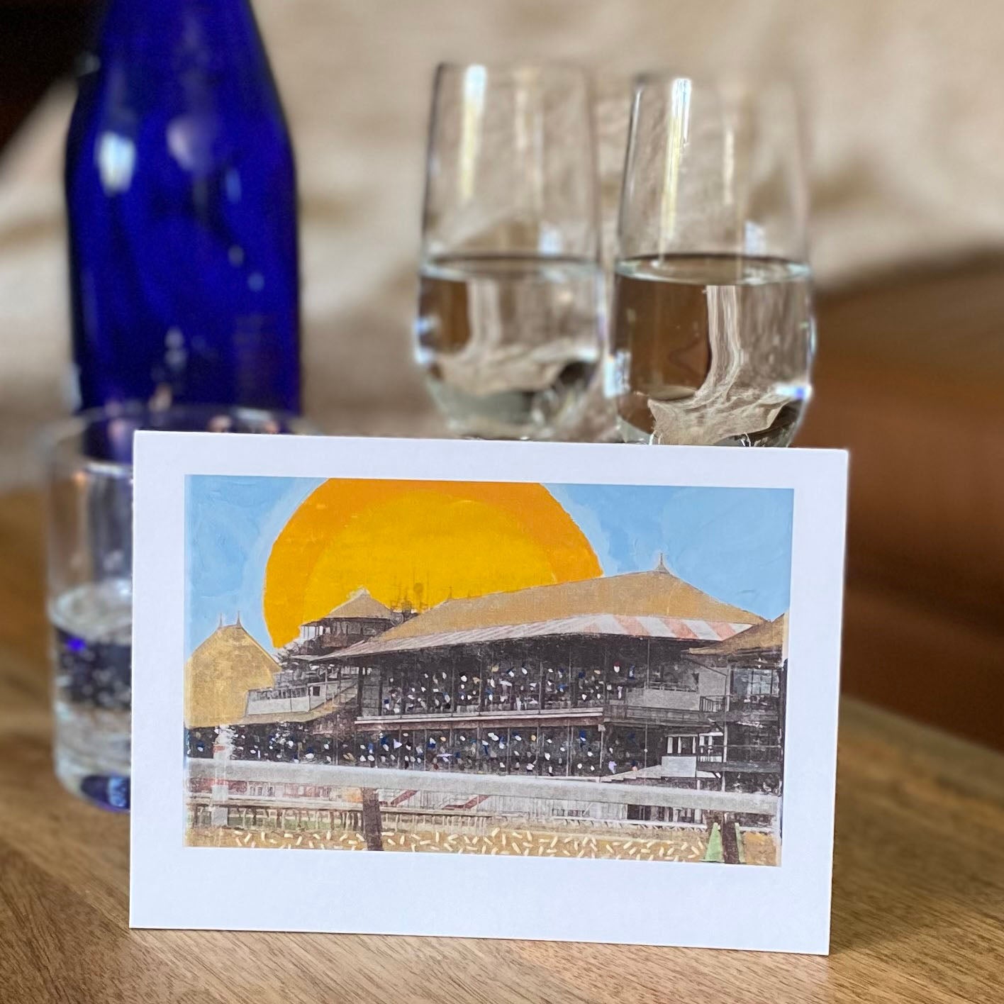 Enjoy Saratoga Sparkling water with your 5"x7" fine art print of the historic Saratoga Racecourse - mixed media with photography, blue, gold, and yellow acrylic paint and embroidery.